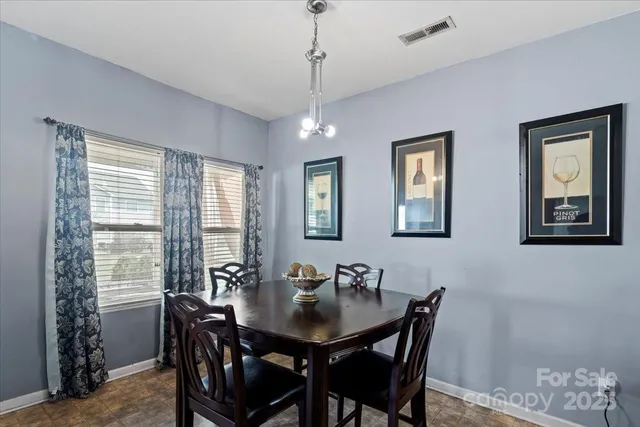 a view of a dining room with furniture and window