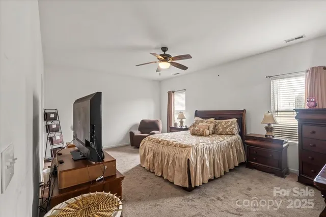 a bedroom with bed and window