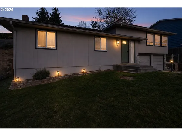 a front view of house with yard and outdoor seating