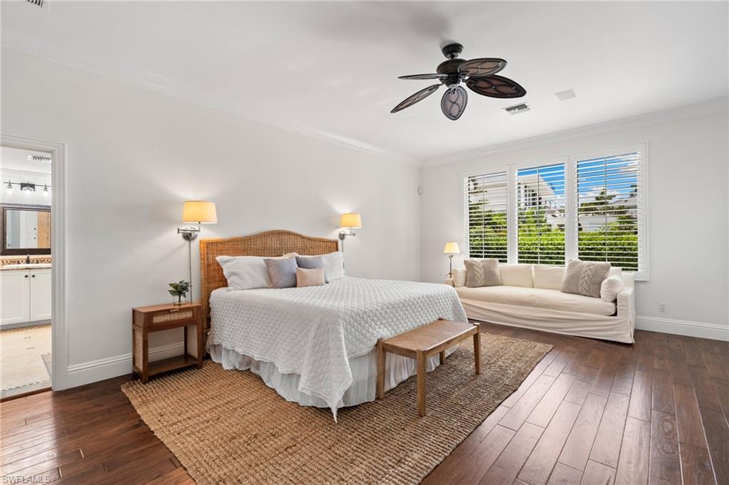 2201 Beacon Lane Naples, FL 34103 - Photo 7 of 25 a bedroom with a bed and wooden floor