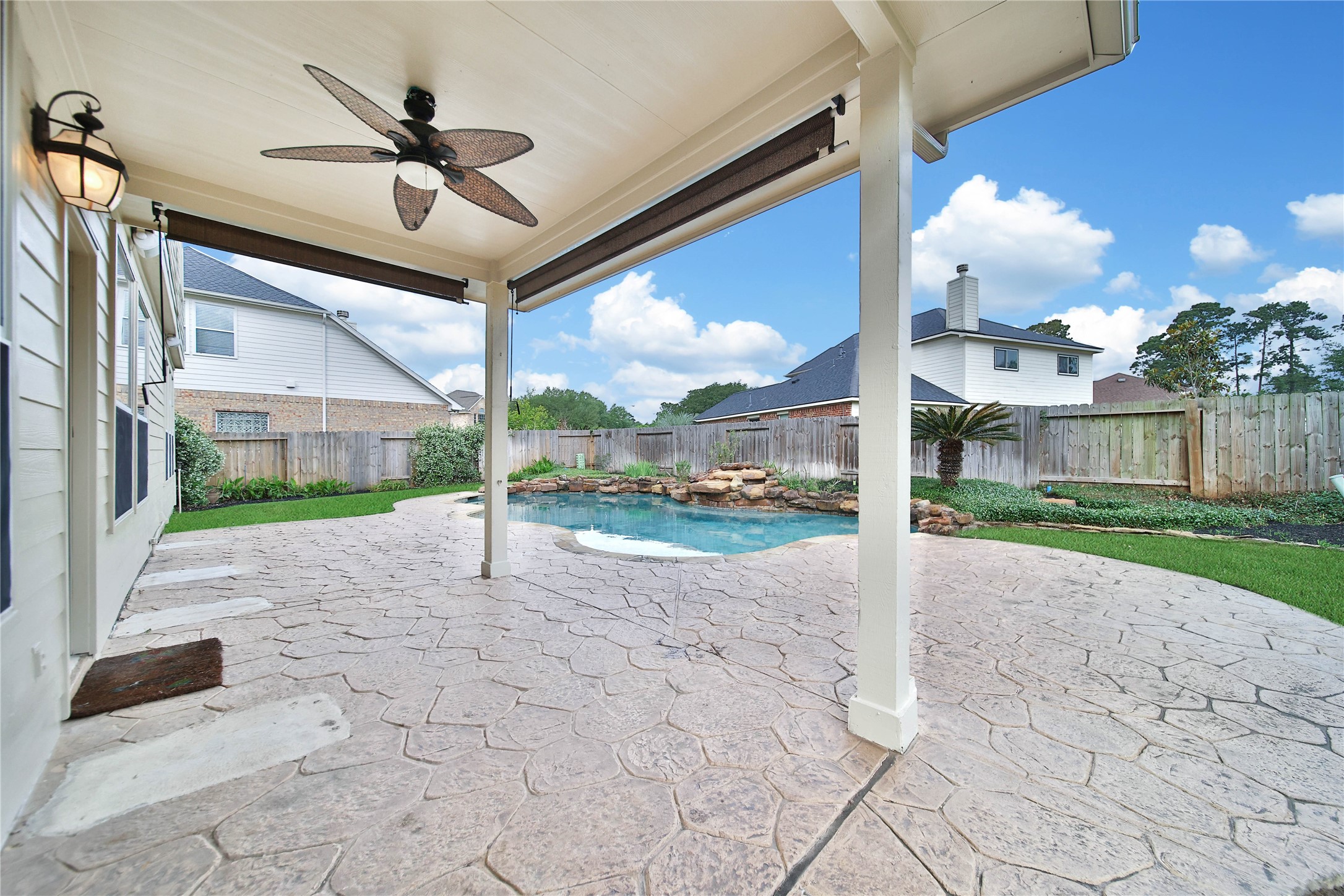 2215 2 Trail Drive Spring, TX 77373 - Photo 41 of 46 The covered back patio includes sun shades for privacy and comfort while enjoying the outdoors.