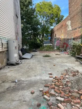 a view of backyard with outdoor seating and plants