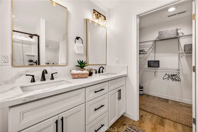 a bathroom with a double vanity sink and mirror