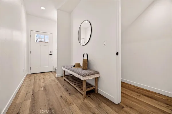 a room with a wooden floor and white walls