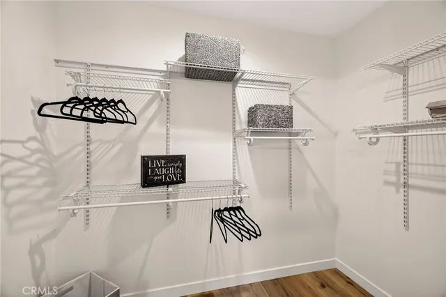 a bedroom with a bed and painting on the wall