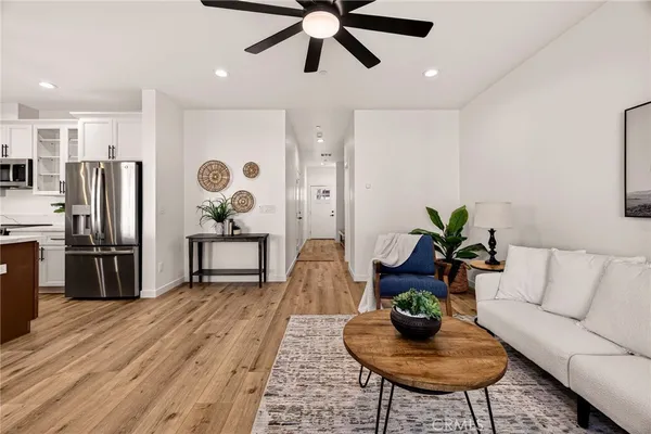 a living room with furniture and a chandelier