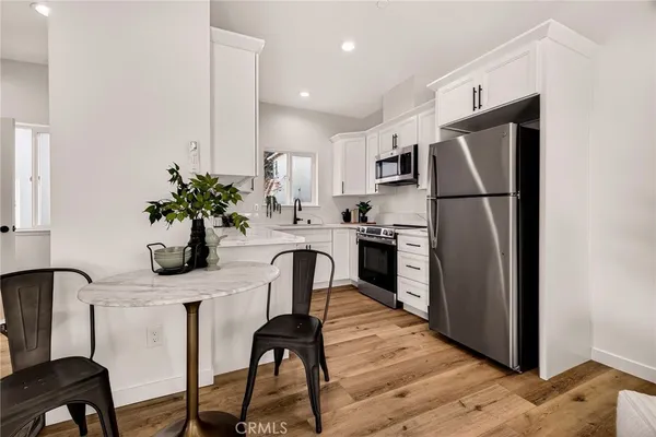 a view of kitchen with furniture and wooden floor