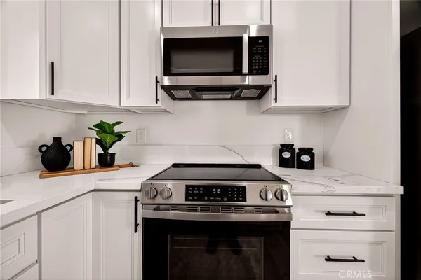 a view of a hallway with wooden floor table and chairs