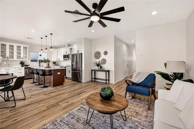 a living room with lots of furniture and kitchen view