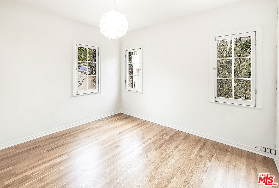 3735 Moore Street Los Angeles, CA 90066 - Photo 12 of 34 an empty room with wooden floor and windows