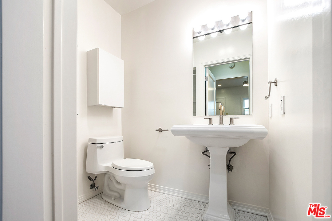 3735 Moore Street Los Angeles, CA 90066 - Photo 13 of 34 a bathroom with a sink toilet and a mirror