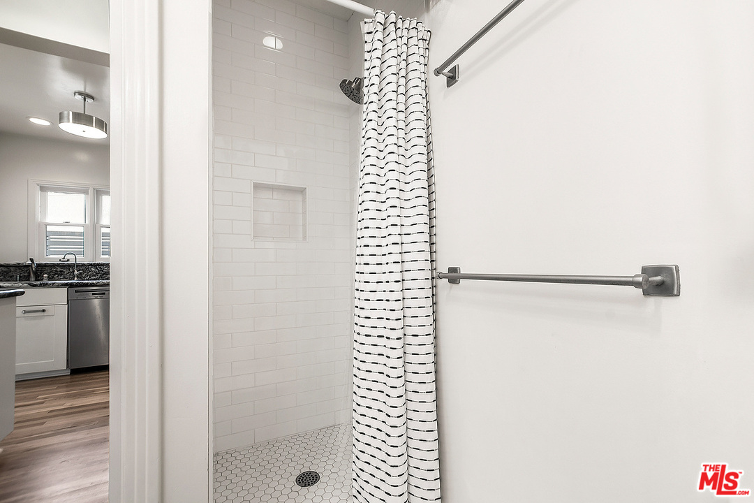3735 Moore Street Los Angeles, CA 90066 - Photo 14 of 34 a bathroom with a shower curtain and a sink