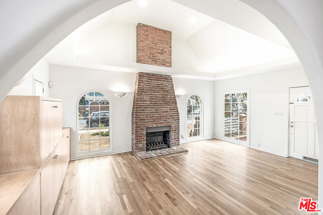 3735 Moore Street Los Angeles, CA 90066 - Photo 4 of 34 a view of an empty room with wooden floor and a fireplace