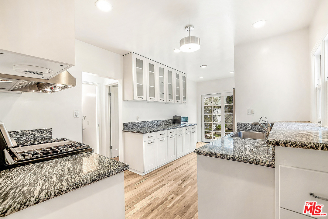 3735 Moore Street Los Angeles, CA 90066 - Photo 8 of 34 a kitchen with granite countertop stainless steel appliances granite countertop a stove and a sink