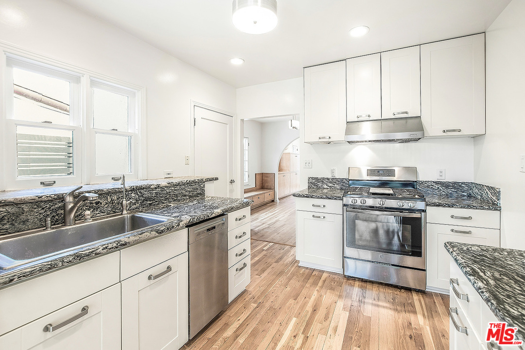 3735 Moore Street Los Angeles, CA 90066 - Photo 10 of 34 a kitchen with stainless steel appliances granite countertop a stove and a sink