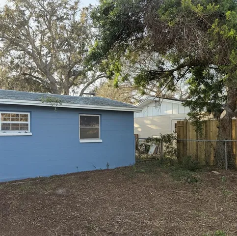 a backyard of a house with table and chairs