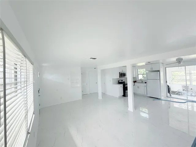 a view of a kitchen with furniture and wooden floor