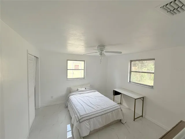 a bedroom with a bed and a window