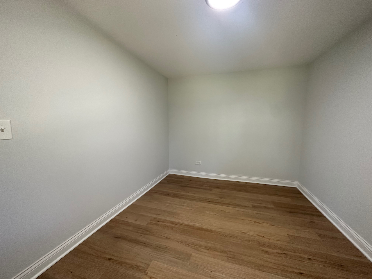 912 East St Charles Road Lombard, IL 60148 - Photo 12 of 27 a view of an empty room with wooden floor