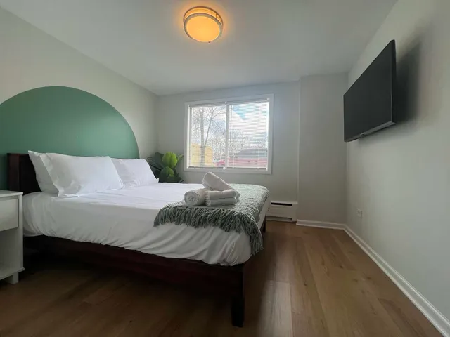 a bedroom with a bed and a flat screen tv