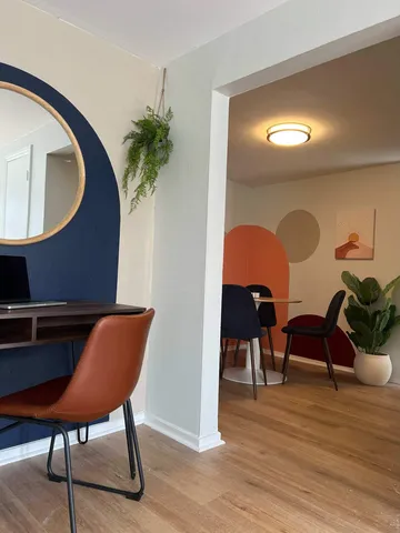 a view of a livingroom with furniture and a potted plant