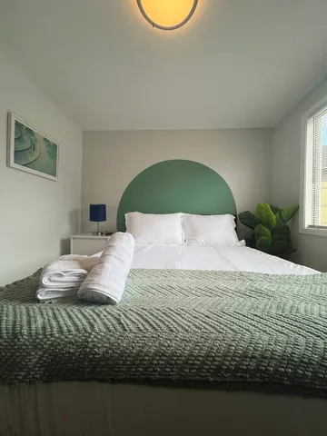 a bed sitting in a bedroom next to a window