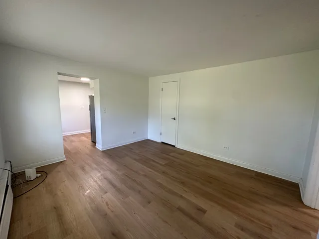 a view of a room with wooden floor