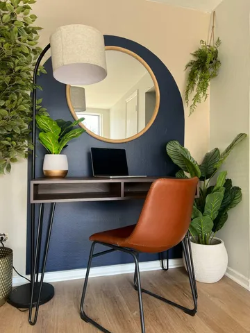 a view of a livingroom with furniture and a potted plant