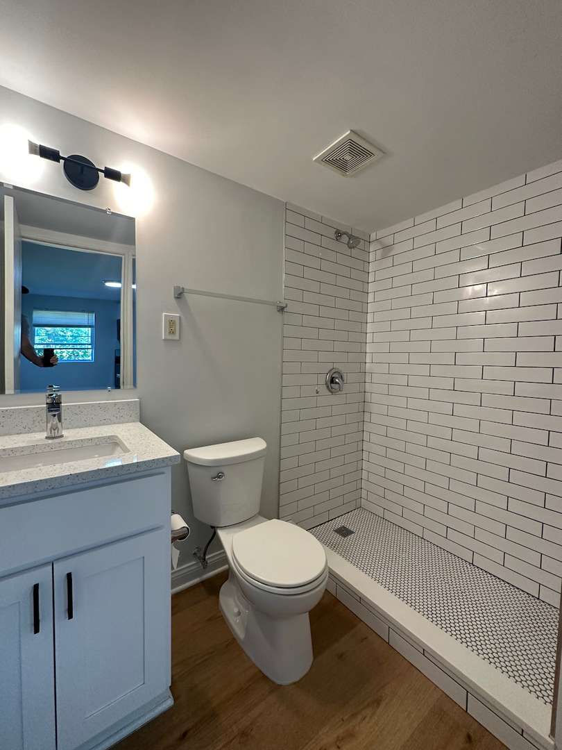 912 East St Charles Road Lombard, IL 60148 - Photo 5 of 27 a bathroom with a sink a toilet and shower