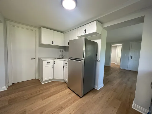 a kitchen with stainless steel appliances granite countertop a refrigerator and a sink