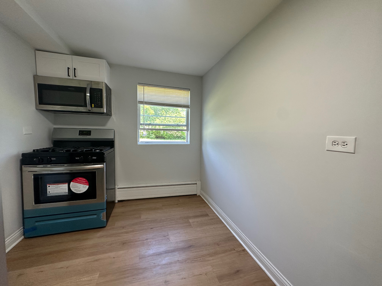 912 East St Charles Road Lombard, IL 60148 - Photo 7 of 27 a view of an empty room with a fireplace and a window