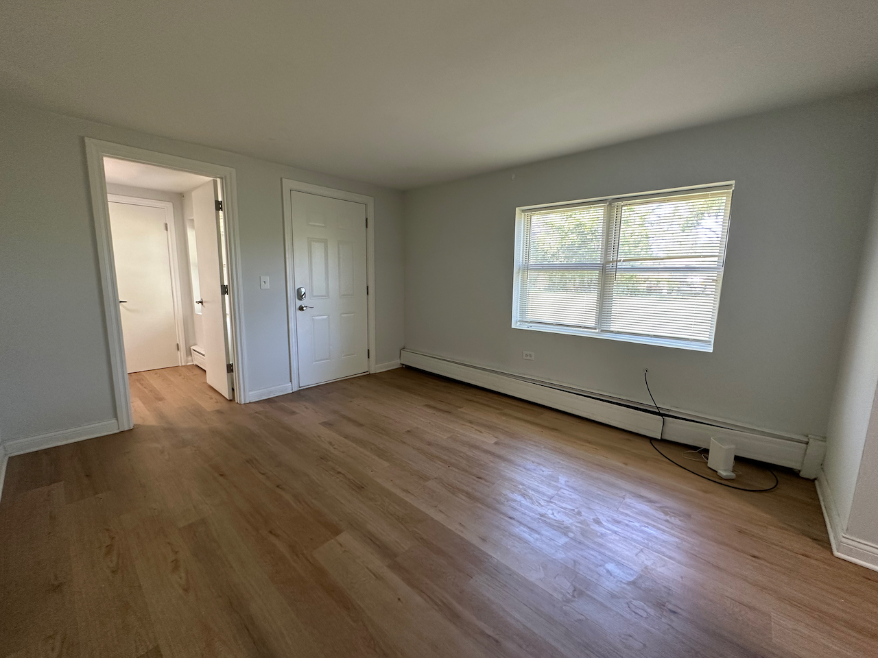 912 East St Charles Road Lombard, IL 60148 - Photo 8 of 27 an empty room with wooden floor and windows