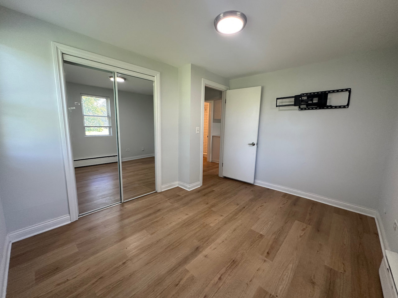 912 East St Charles Road Lombard, IL 60148 - Photo 9 of 27 an empty room with wooden floor and windows