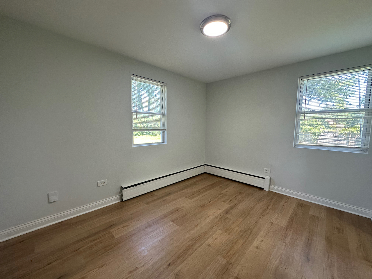 912 East St Charles Road Lombard, IL 60148 - Photo 10 of 27 an empty room with wooden floor and windows