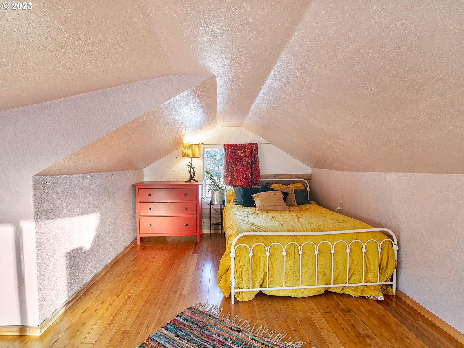 8034 Southeast Henderson Street Portland, OR 97206 - Photo 16 of 23 a bedroom with a bed and wooden floor