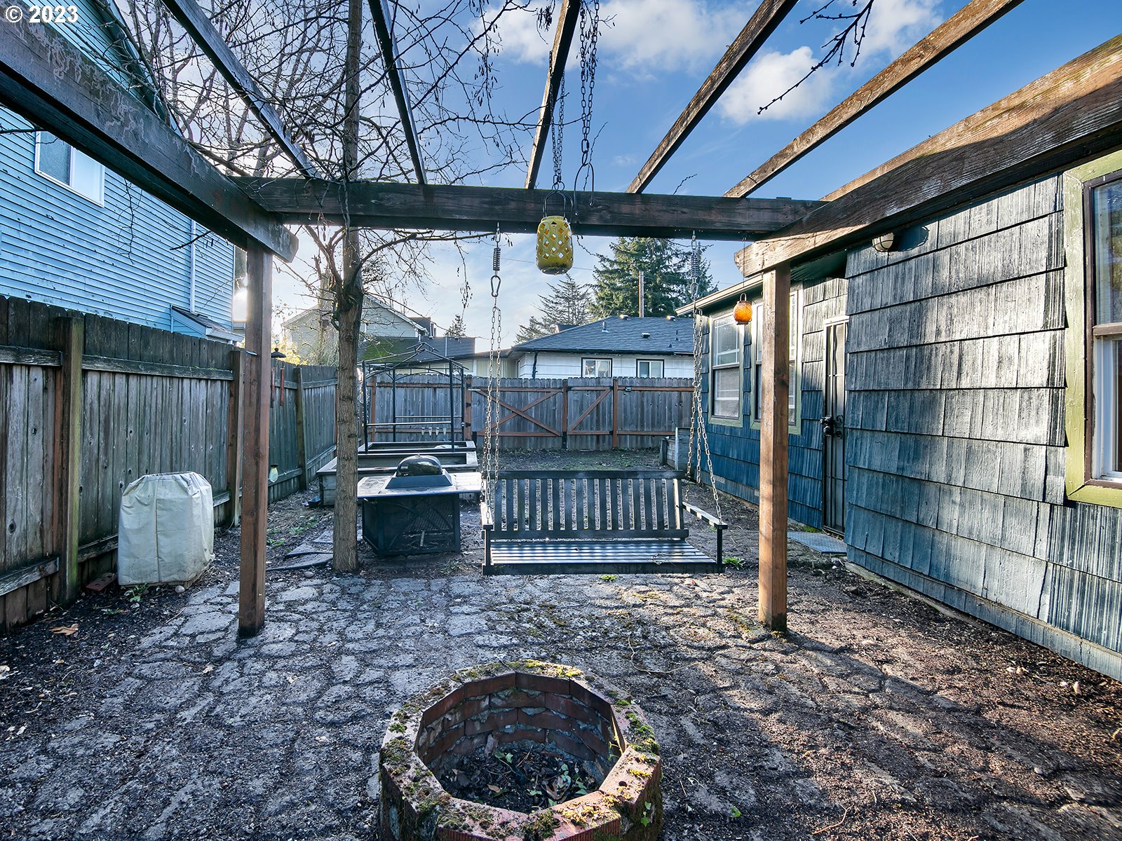 8034 Southeast Henderson Street Portland, OR 97206 - Photo 3 of 23 a backyard of a house with sofas table and chairs