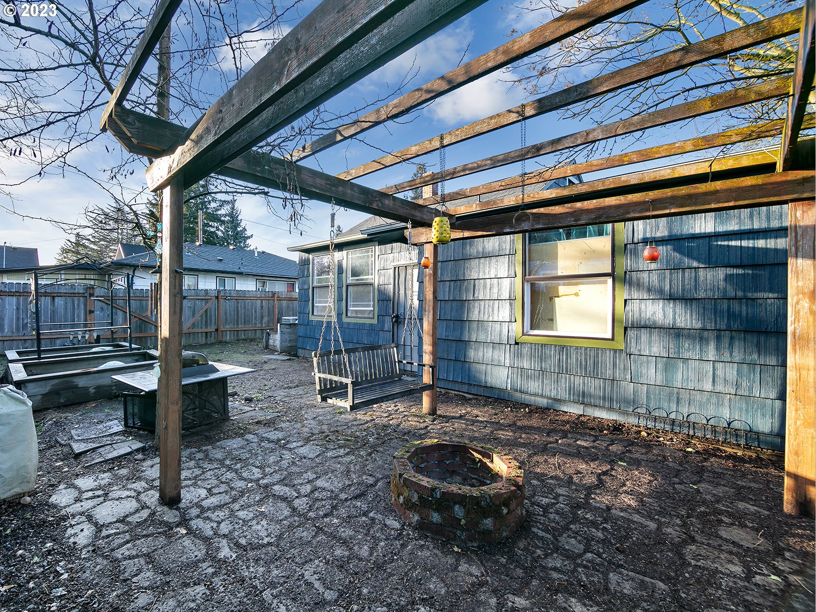 8034 Southeast Henderson Street Portland, OR 97206 - Photo 4 of 23 a backyard of a house with barbeque oven table and chairs