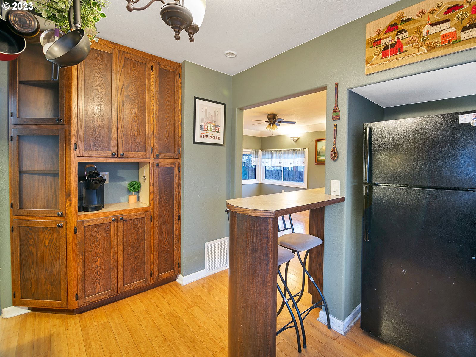 8034 Southeast Henderson Street Portland, OR 97206 - Photo 7 of 23 a view of kitchen with furniture and a refrigerator