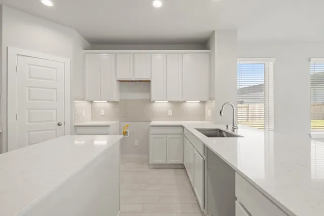 a kitchen with a sink stove and cabinets