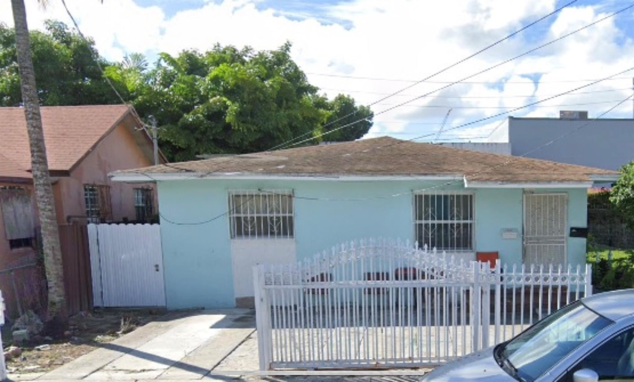 a view of a house with wooden fence