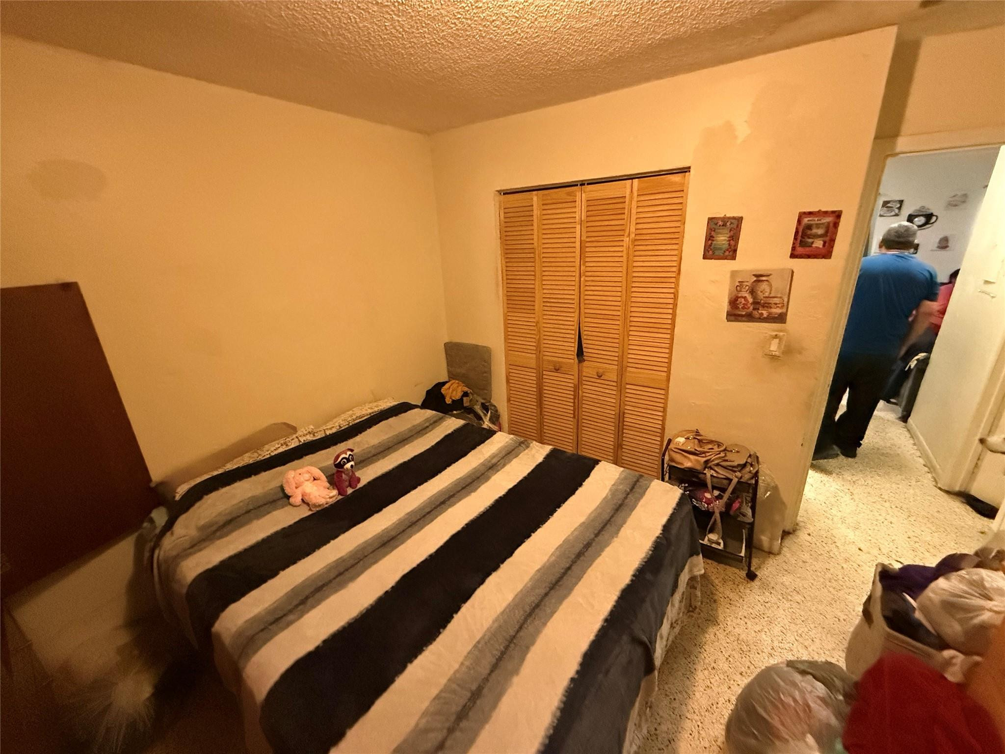 1028 Northwest 24th Street Miami, FL 33127 - Photo 18 of 24 a bed sitting in a bedroom next to a window