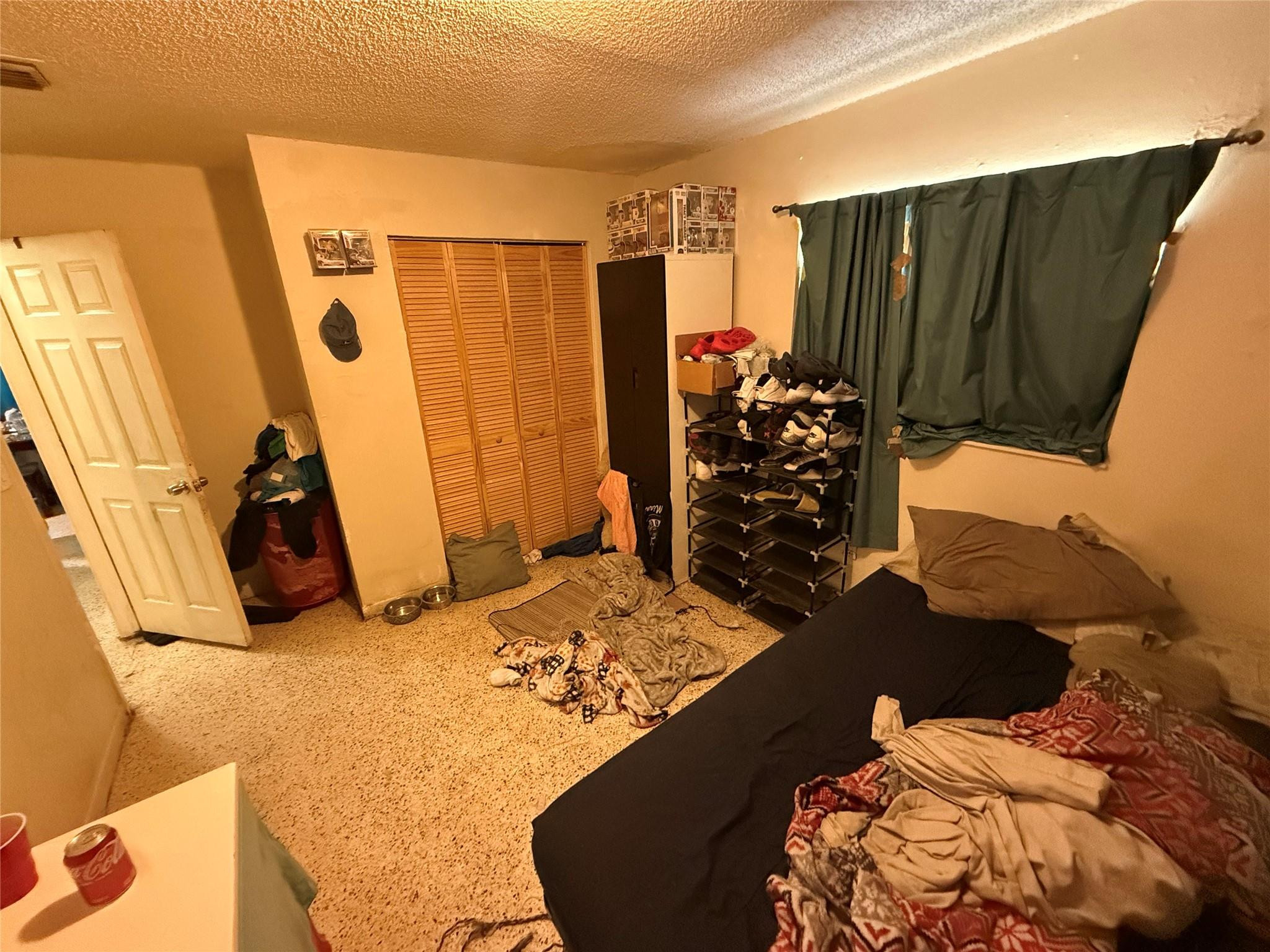 1028 Northwest 24th Street Miami, FL 33127 - Photo 20 of 24 a bed room with a bed and a walk in closet