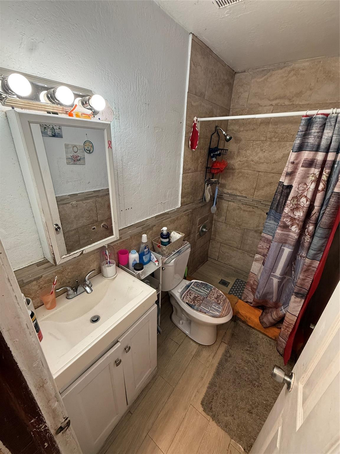 1028 Northwest 24th Street Miami, FL 33127 - Photo 2 of 24 a bathroom with a sink toilet and shower