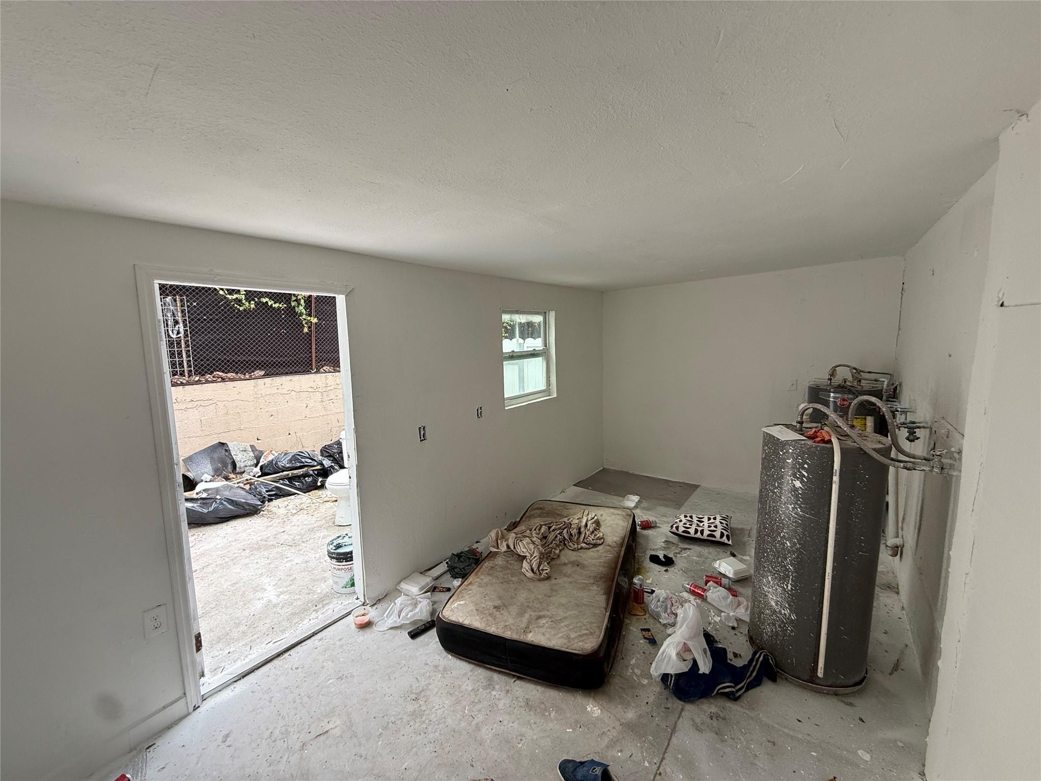 1028 Northwest 24th Street Miami, FL 33127 - Photo 22 of 24 a bedroom with furniture and a window