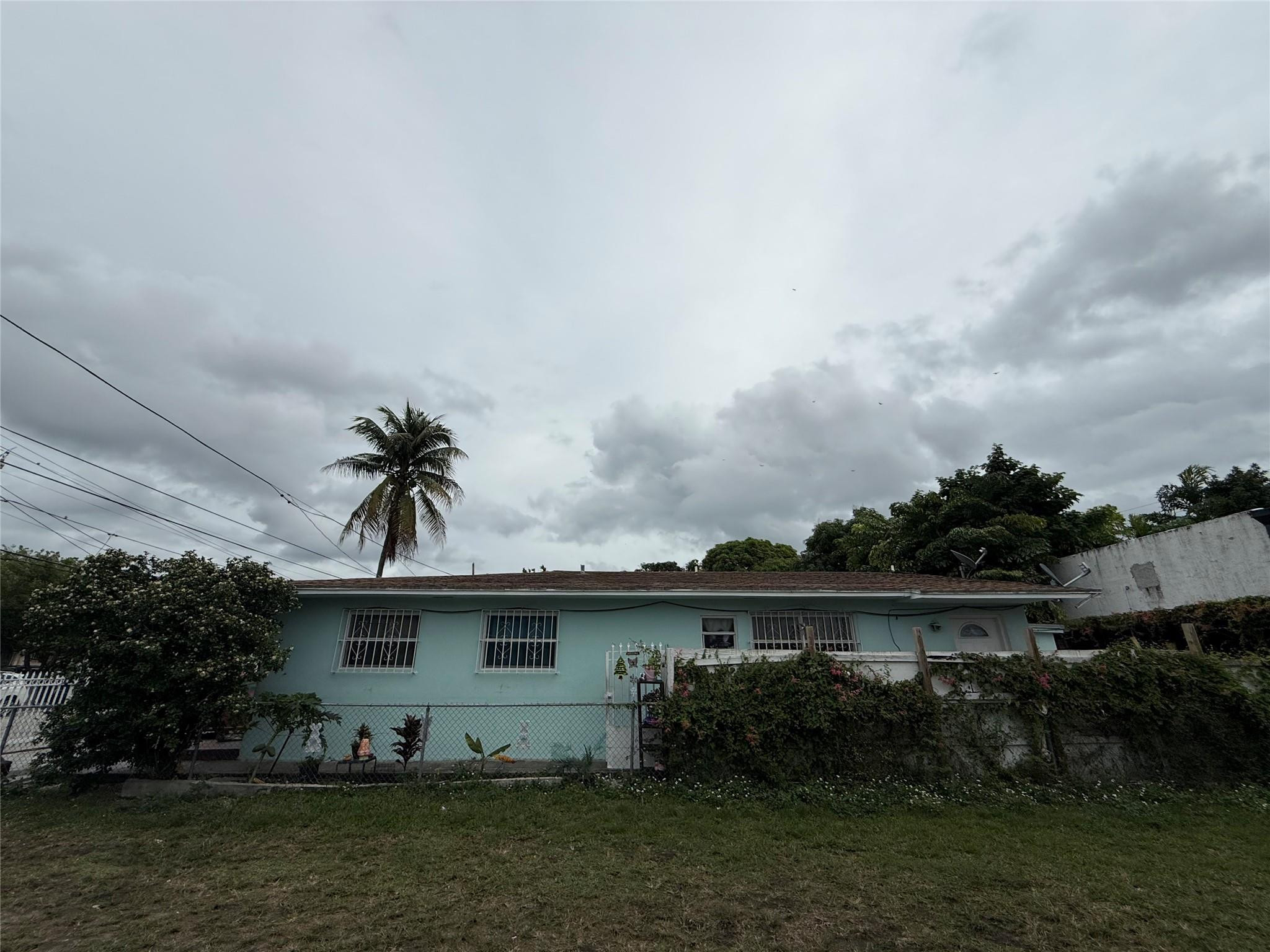 1028 Northwest 24th Street Miami, FL 33127 - Photo 23 of 24 a front view of a house with garden