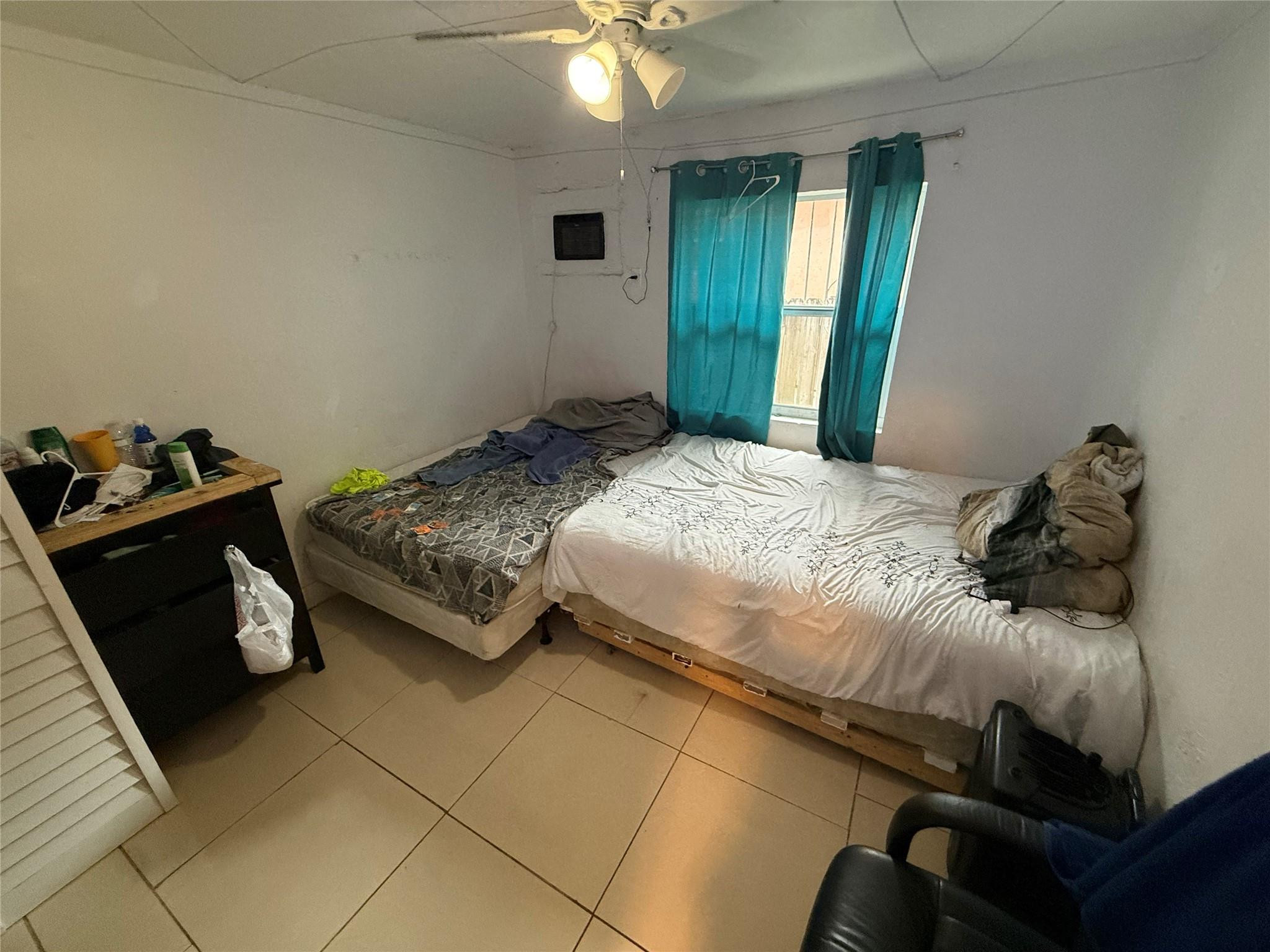 1028 Northwest 24th Street Miami, FL 33127 - Photo 5 of 24 a bedroom with a bed and a window