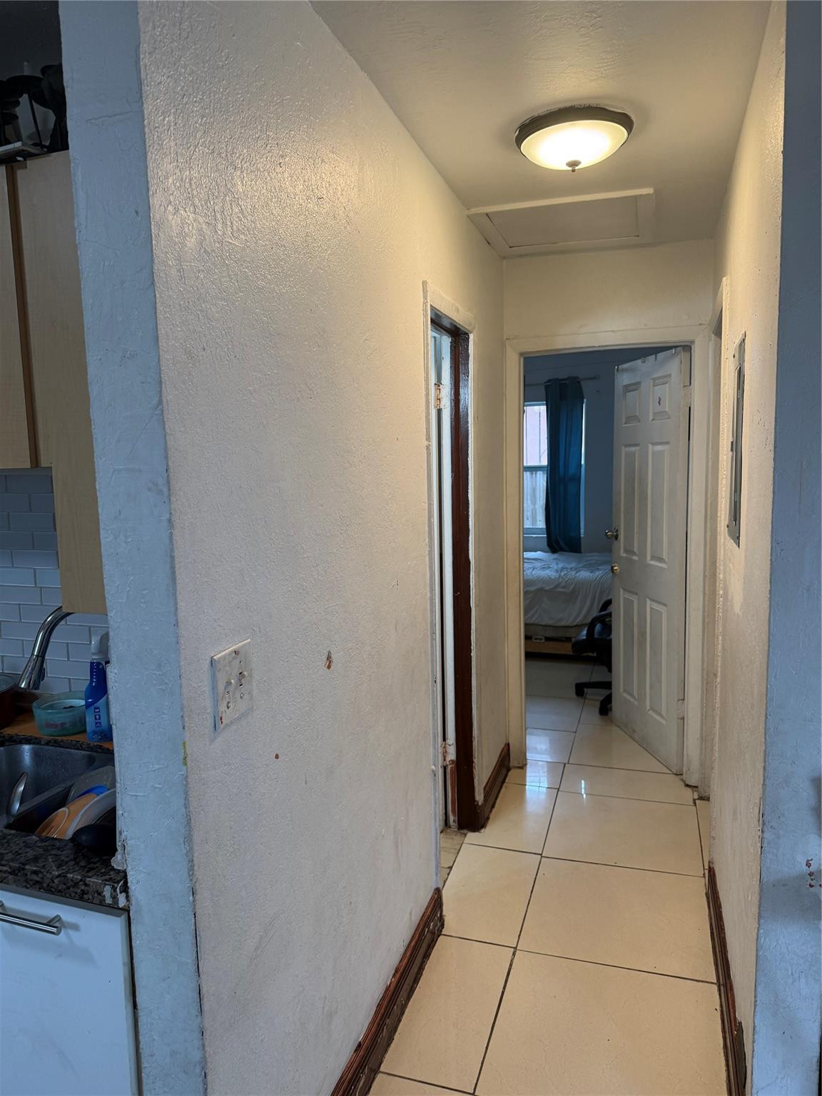 1028 Northwest 24th Street Miami, FL 33127 - Photo 9 of 24 a view of a hallway to a livingroom and a livingroom with furniture
