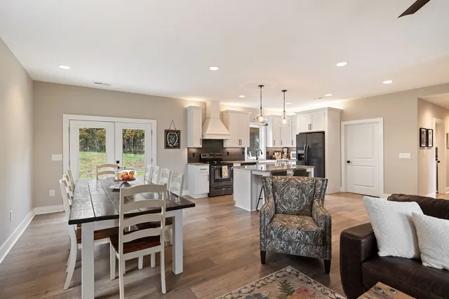 a living room with furniture and kitchen view