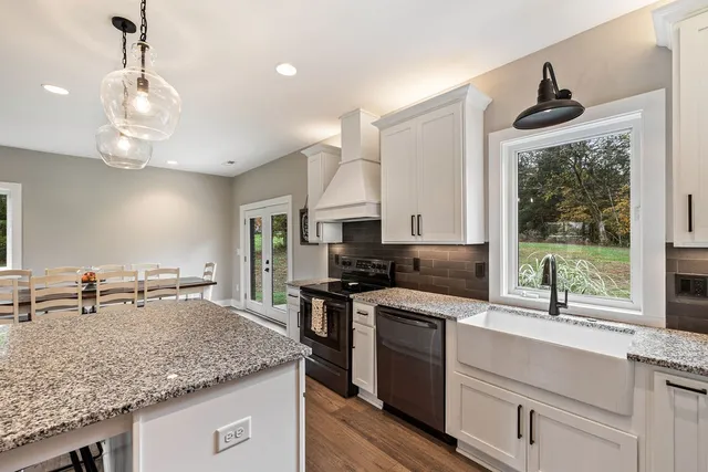 a kitchen with stainless steel appliances granite countertop a sink and stove