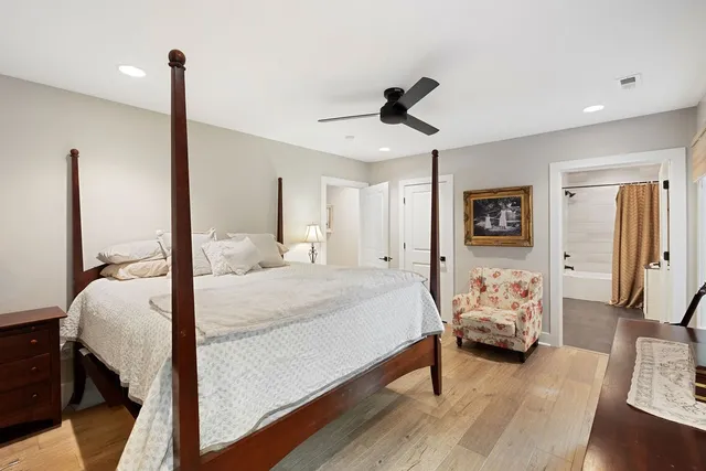 a bedroom with a bed and wooden floor